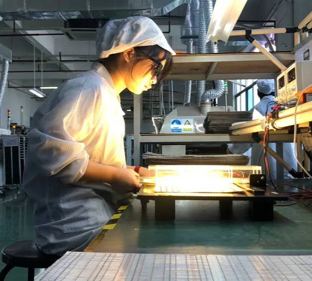 LED Factory worker in Shenzhen Testing light output of LED strips