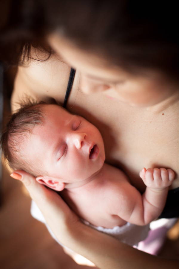 small baby sleeping skin to skin on mother's chest