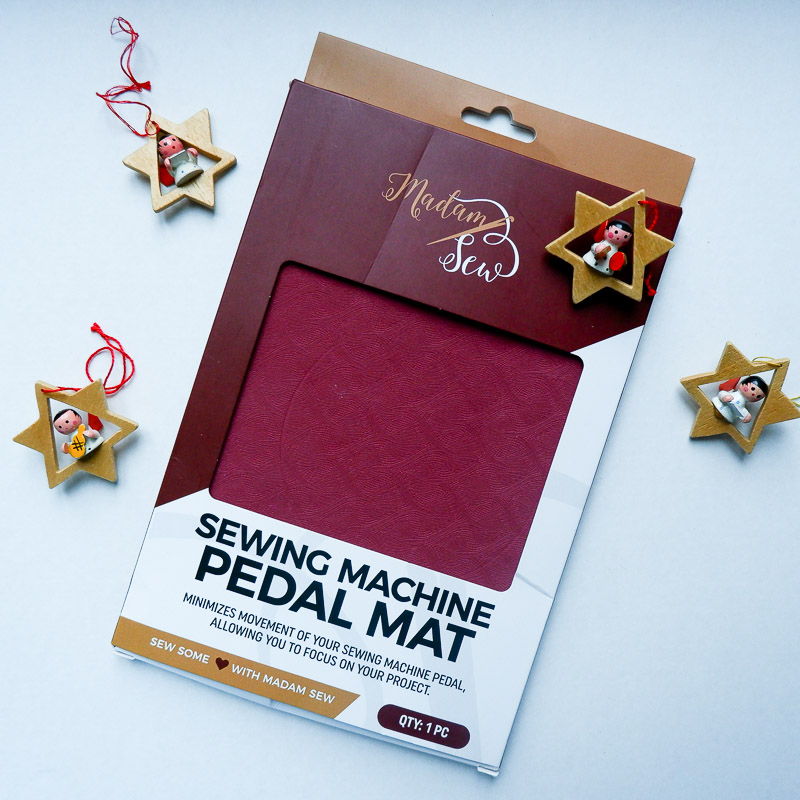 a pedal mat on a white table with christmas ornaments
