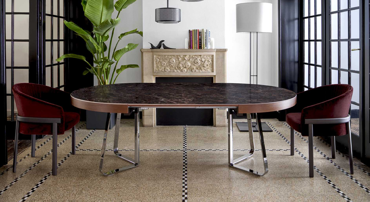 Modern dining room with a round table and red chairs.