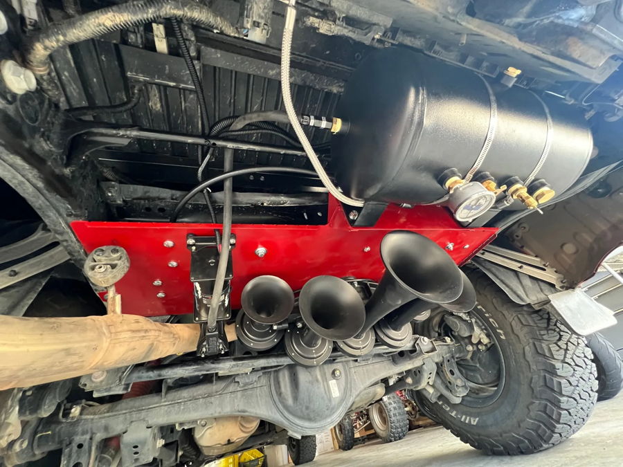 Four train horns red mounting plate black air tank pressure gauge solenoid rear differential BFGoodrich tire Brandon's 2024 Tundra K5LA 544 undercarriage gallery photo 3