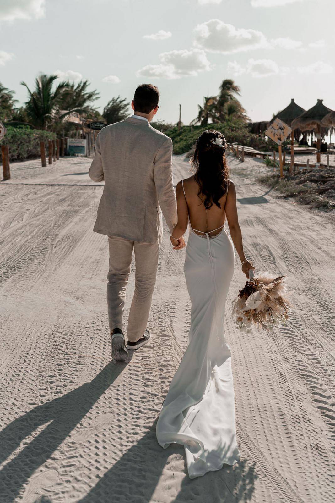 Bride and groom. walking away on the beach