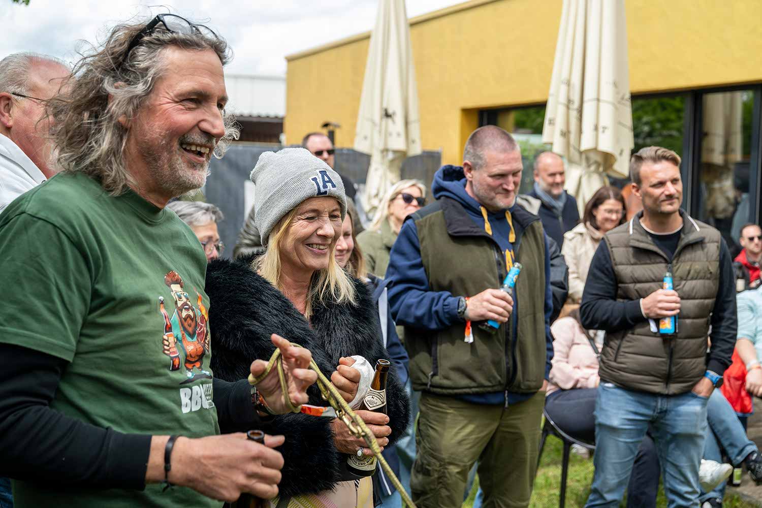Group of people enjoying an outdoor event, smiling and interacting.