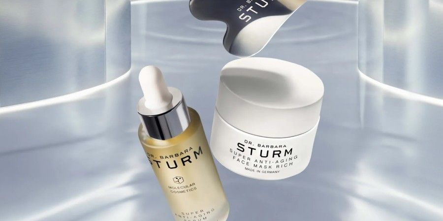 Two skincare products from Sturm on a reflective surface.