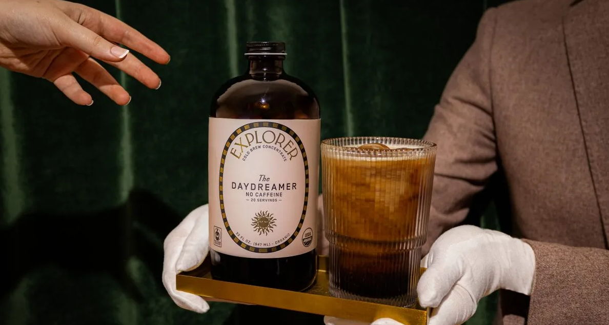 A person in gloves serving a drink and a bottle.