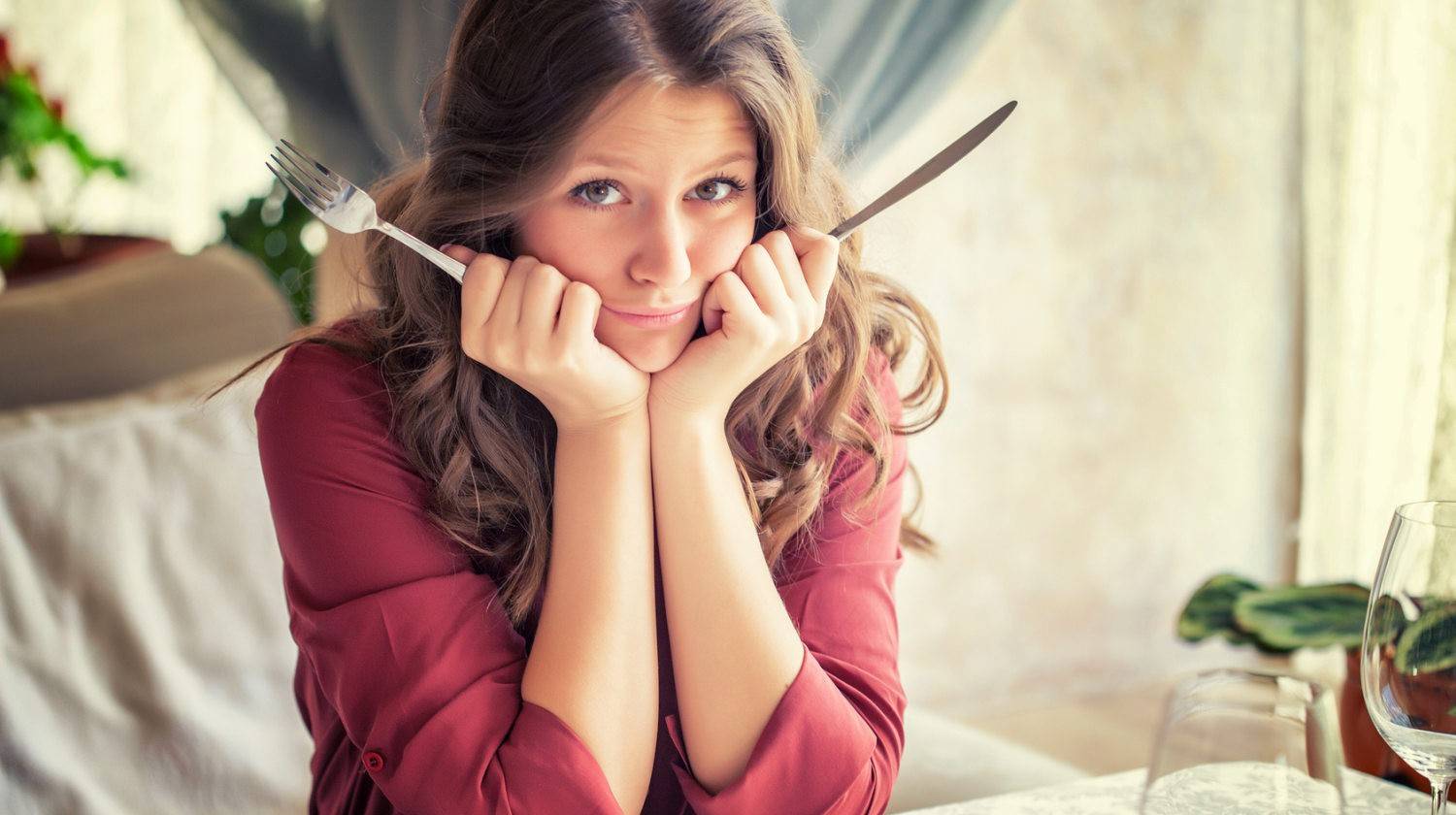 Featured | Woman holding fork and knife hungry | Craving Control: Most Common Cravings, Their Causes, And How To Control Them