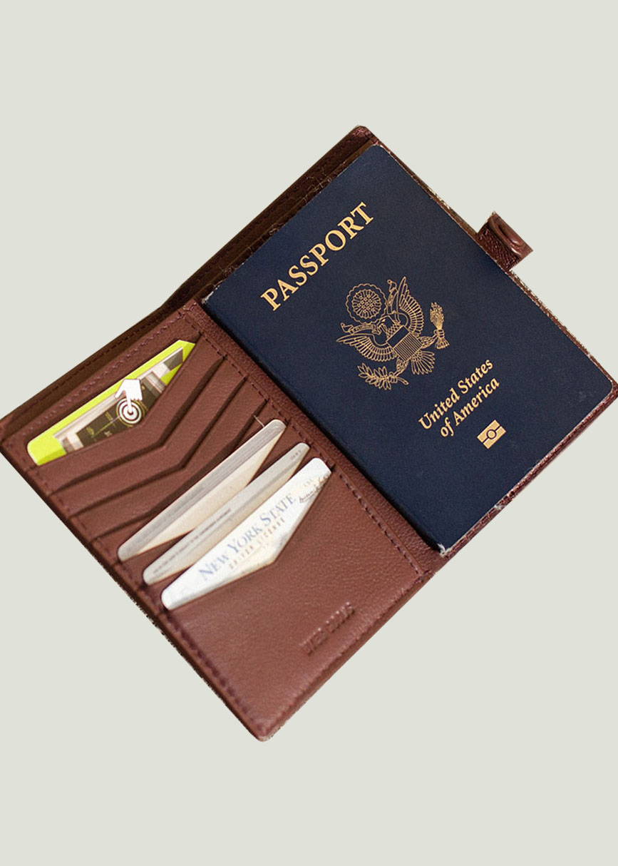 an open passport wallet with cards inside on the left and a passport inside on the right