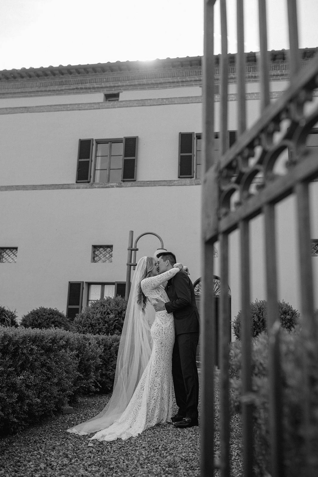 Black and white image of Bride and Groom sharing a kiss