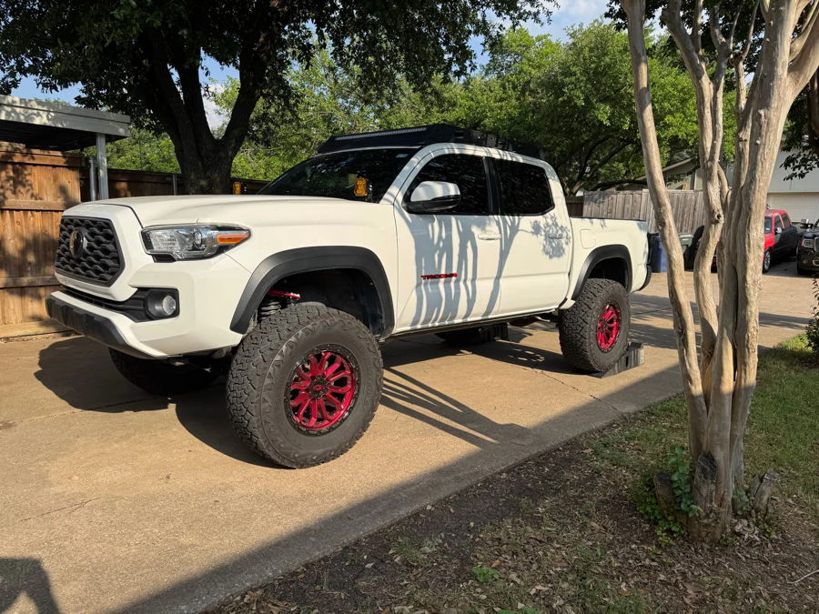 Driver side white Tacoma red wheels roof rack ditch lights ramps wooden fence Joel's 2-Chime 3-Liter gallery photo 4