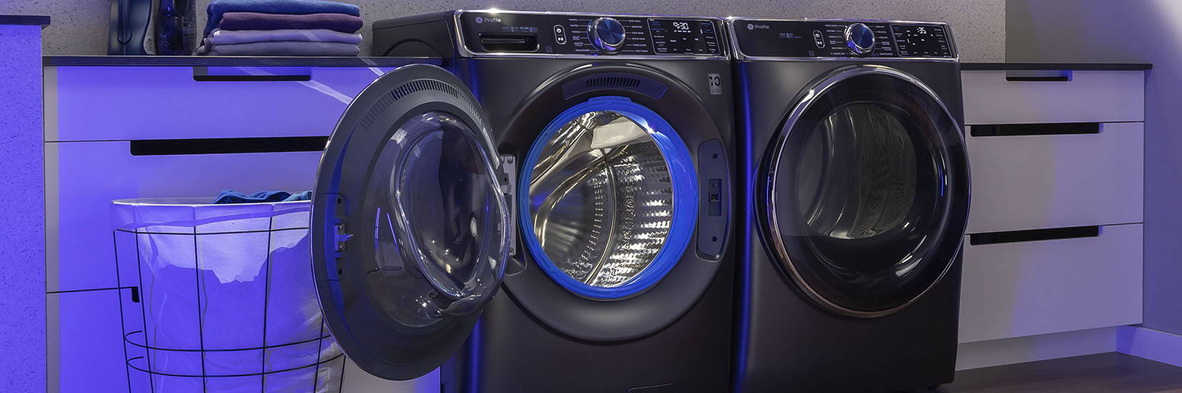GE Profile Front load washer and dryer with washer door open, showcasing microban blue gasket.