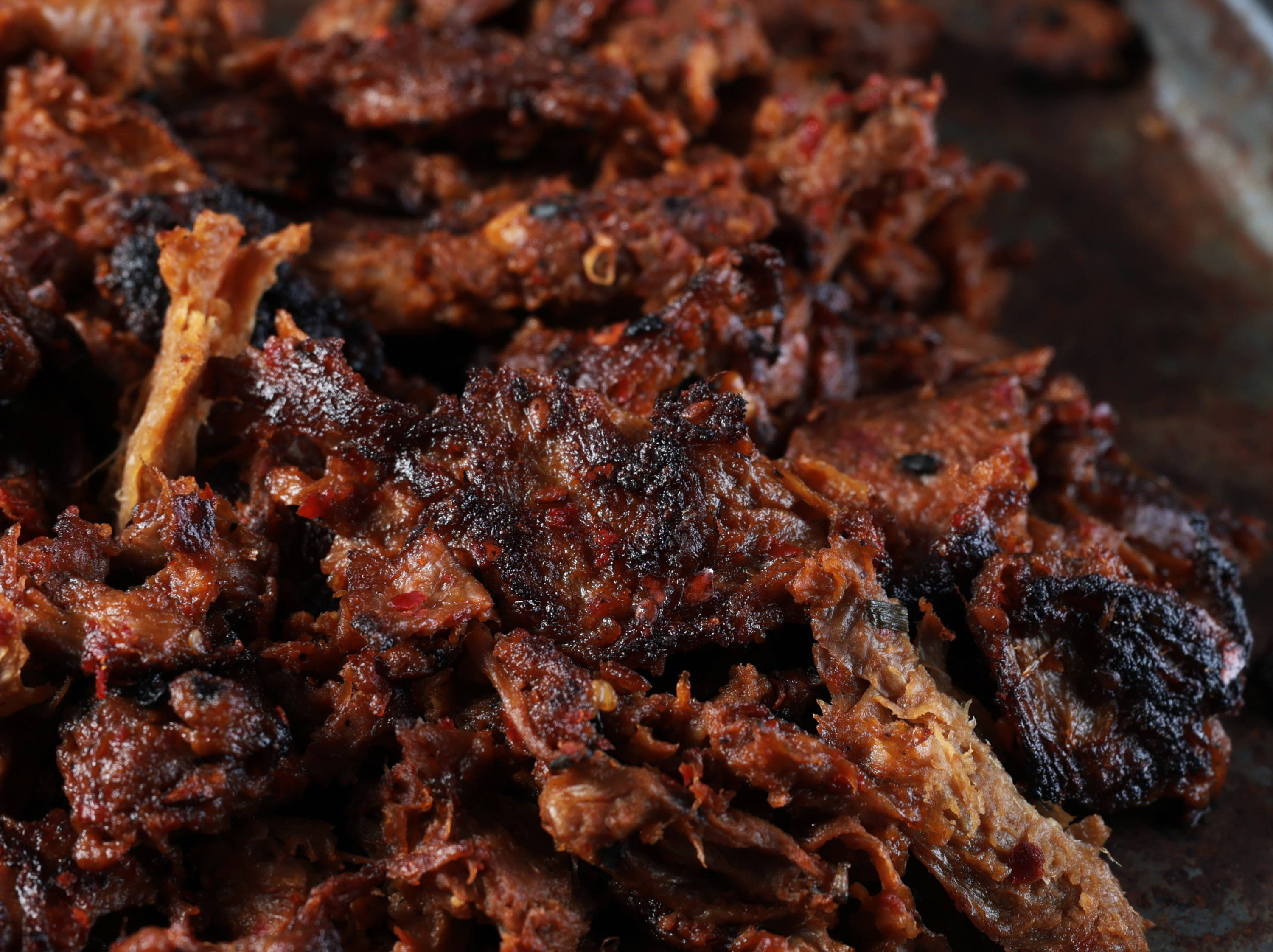 Close up of Harvest Shreds resembling shredded meat, with bits of char