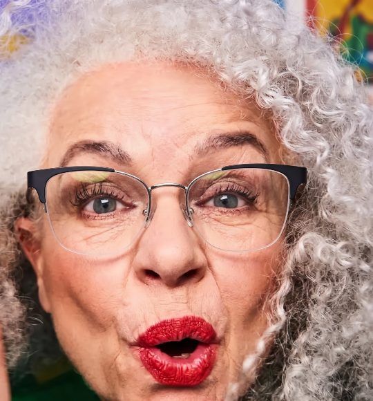 Old woman with grey hair wearing Enchanted Silver semi-rimless cat eye glasses that make you look younger