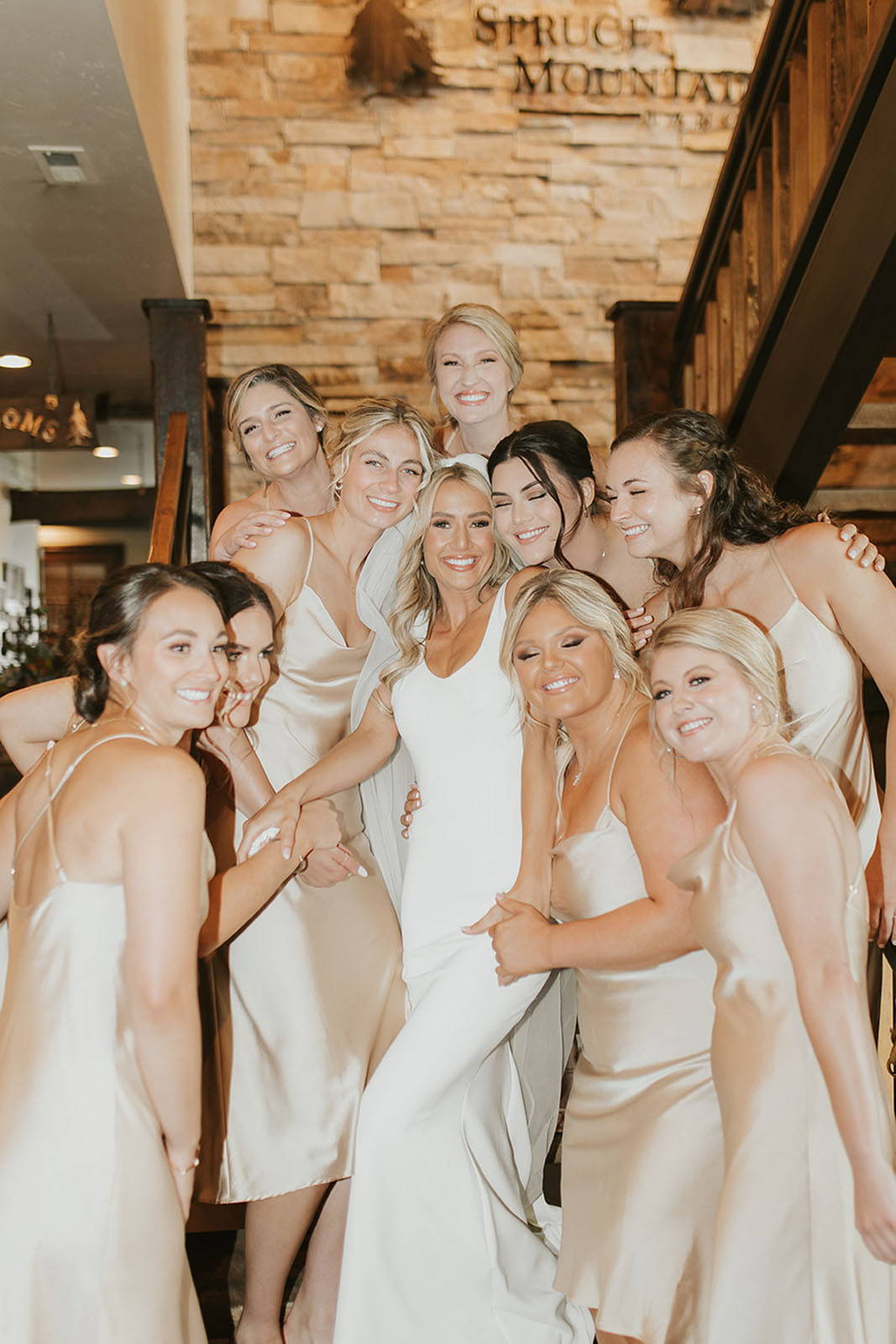 The stunning bride strikes a graceful pose, surrounded by her beaming bridesmaids