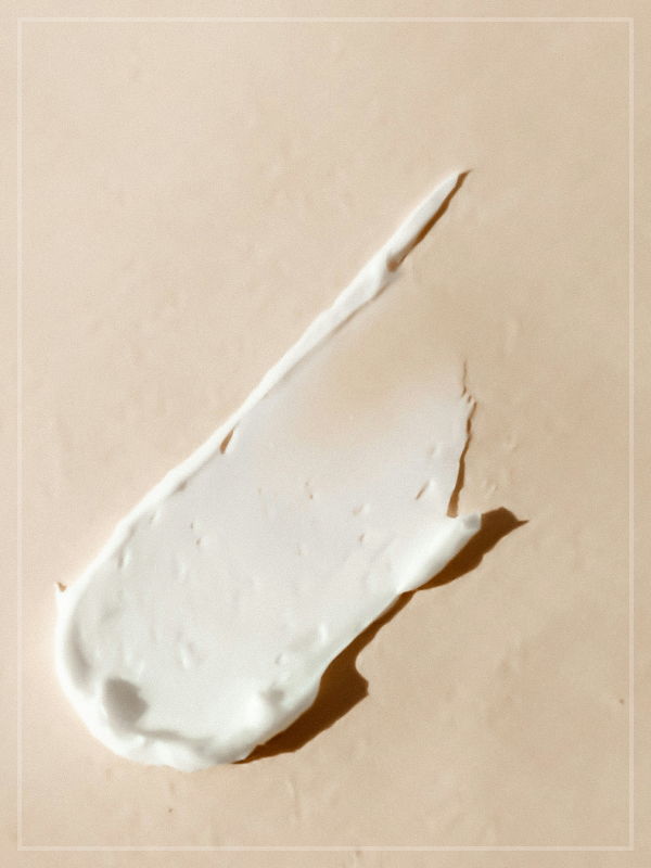 A smear of makeup cream on an adobe surface