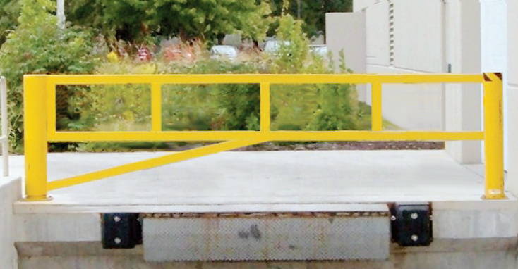 Yellow Dock Gate On shipping dock with additional bollard used as a stopper.