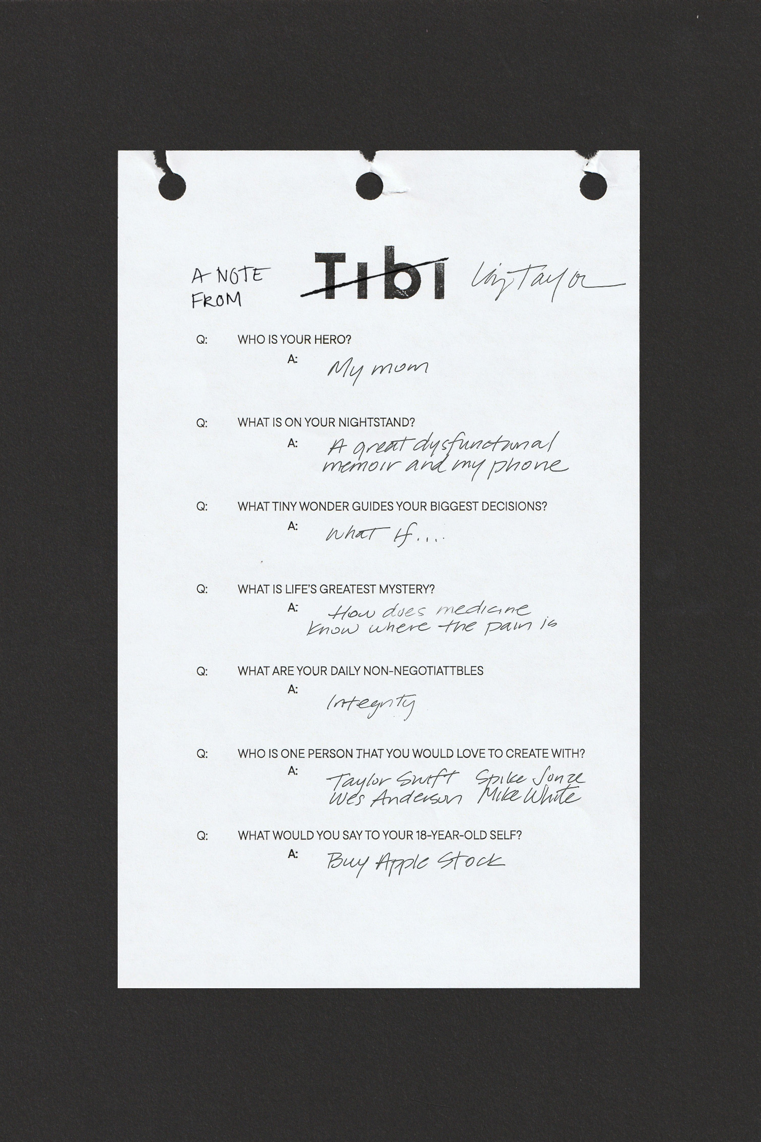 A handwritten note frm Liz Taylor on a white paper with black background.