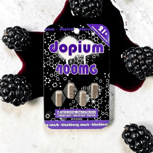 Blackberries surrounding a package of Dopium 400mg supplement.