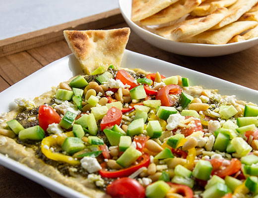 Image of Layered Hatch Chile Hummus Dip with Toasted Pita Chips