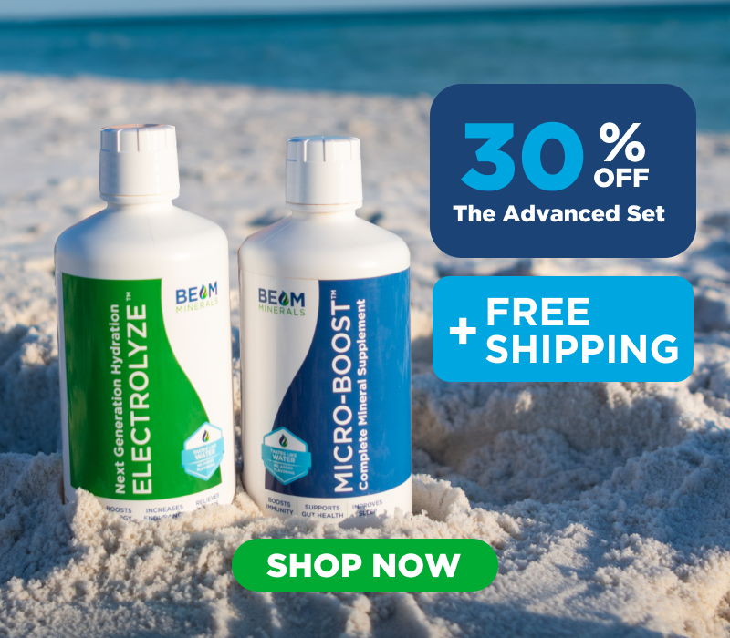 Two bottles of skincare products on the beach with promotional text.
