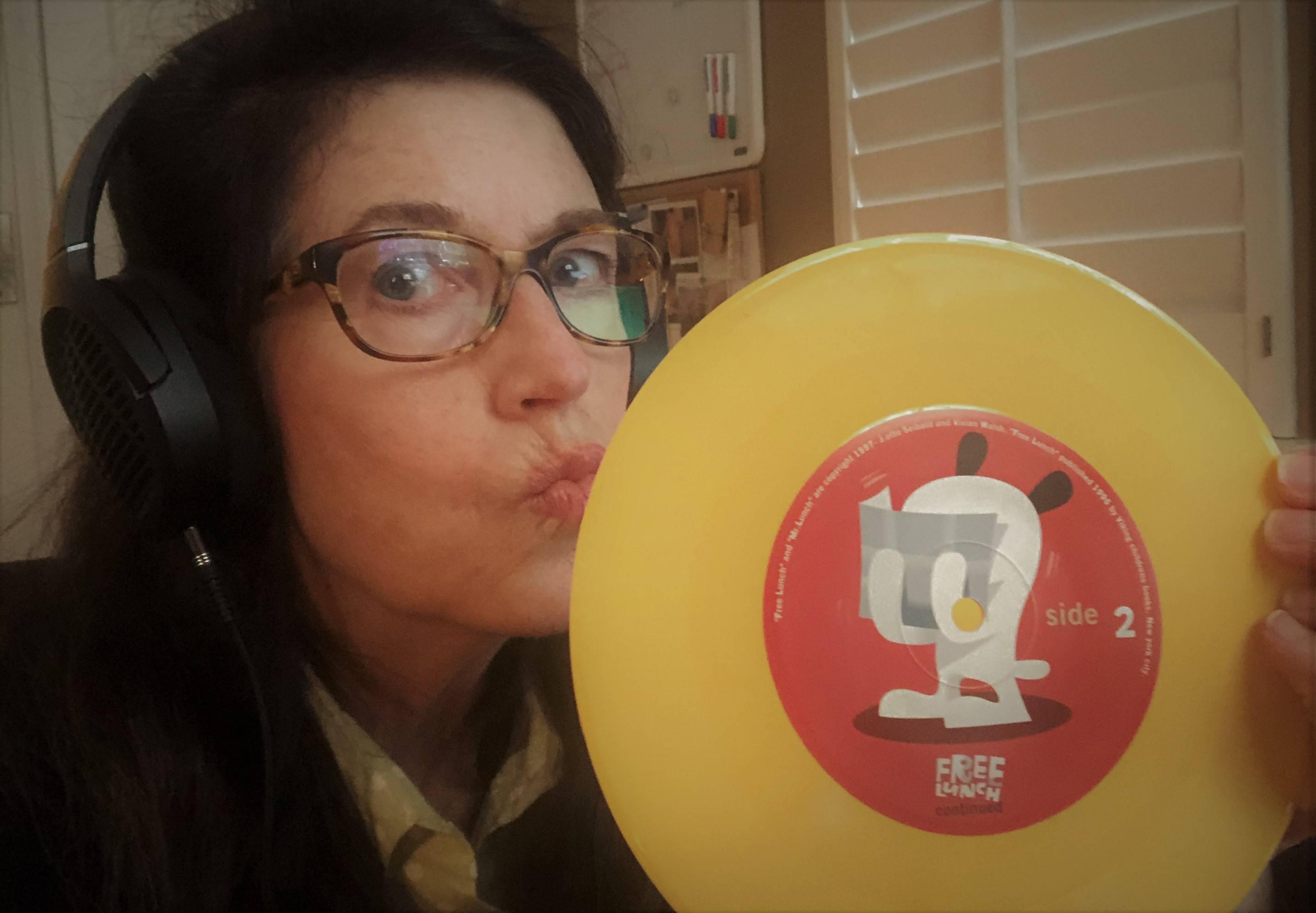 Susan Rogers kissing her Free Lunch album while wearing LCD-1 headphones