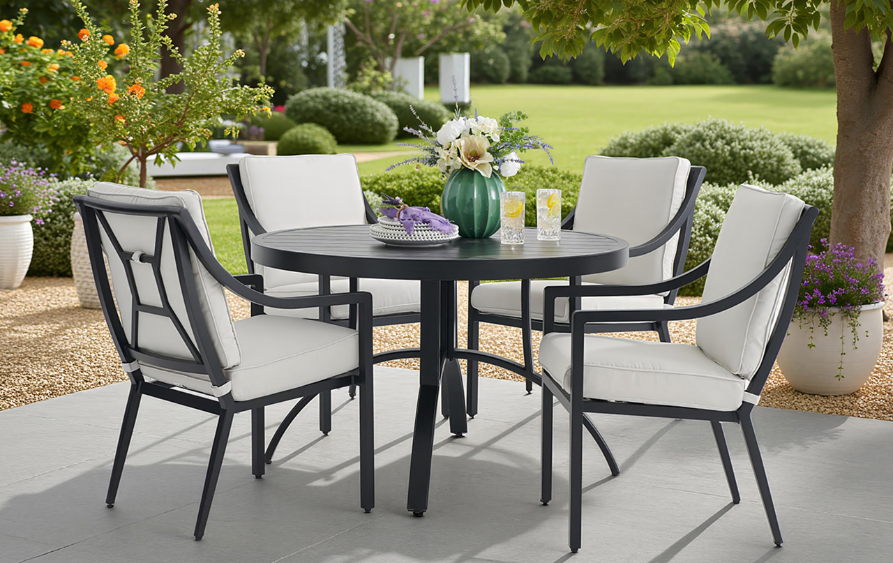 Outdoor dining set with chairs and table in a garden setting.