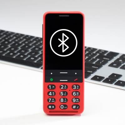 Cardinal Red BlindShell Classic 2 with a wireless keyboard and BlueTooth logo for pairing your devices.