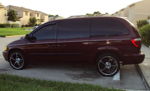 Side profile maroon minivan chrome deep-dish wheels dark tint parking lot townhomes Leonard's 2003 Caravan 232 gallery photo 2