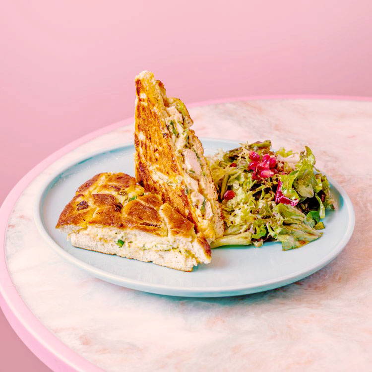 Chicken Focaccia with salad on marble table