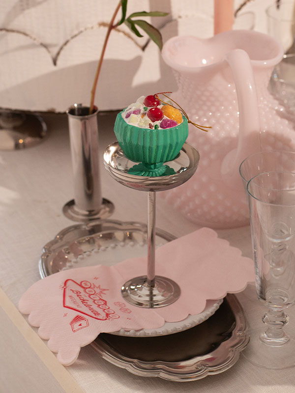 A dessert display featuring a colorful cupcake on a tiered stand.