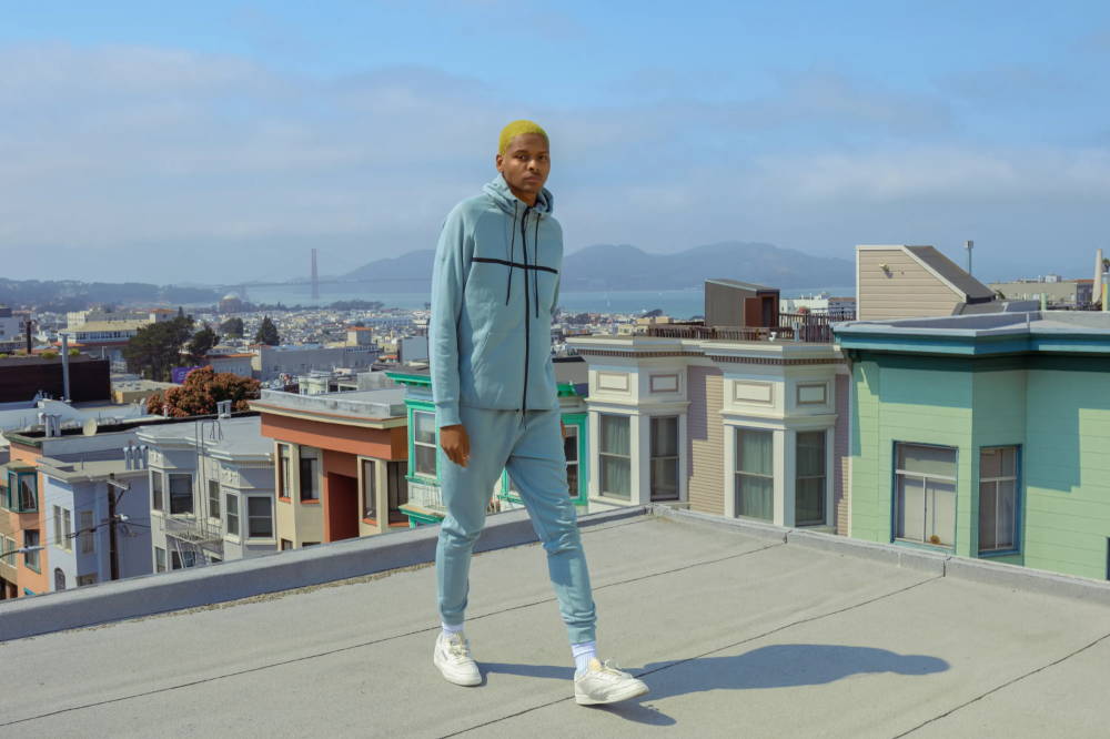 male model on rooftop wearing particle matching set in teal
