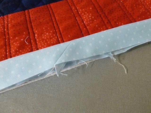 Detail of a mitered seam on a quilt binding
