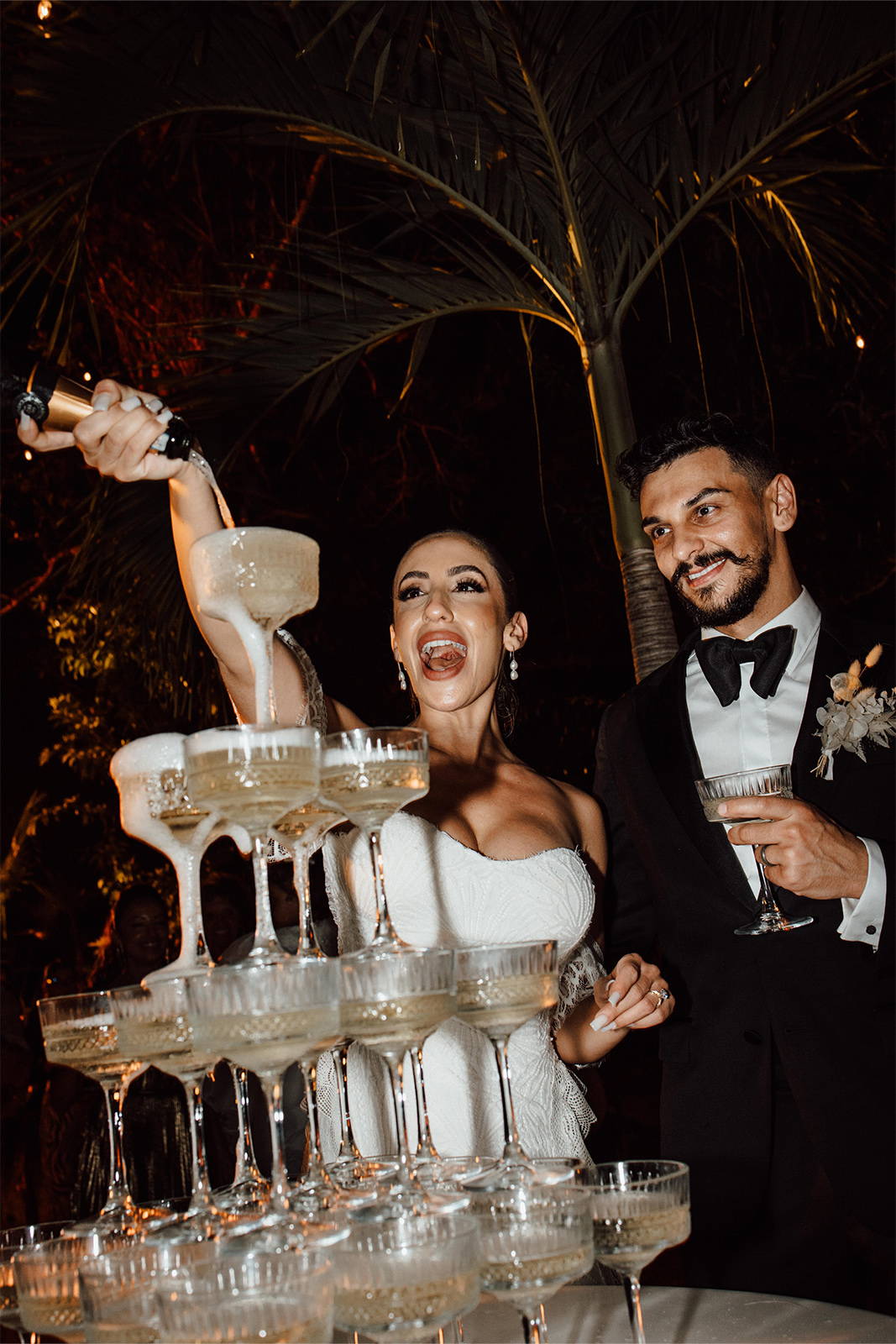 Bride and groom pouring the champagne tower