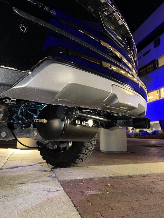 Nighttime rear undercarriage view Stealth Spare Tire Delete air tank and horn behind bumper on Troy's 2018 Ford Expedition gallery photo 16
