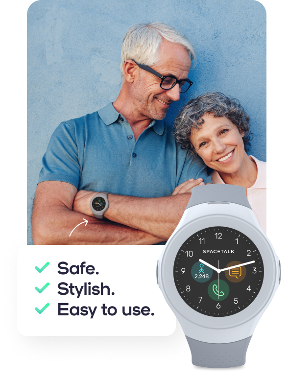 A smiling senior couple, the man with arms folded, wearing a Spacetalk Life device on his wrist