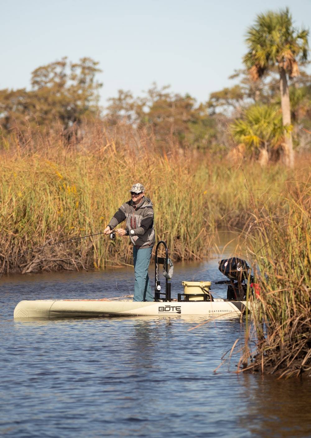 Man fishing from his Rover 14′ Verge Camo Micro Skiff
