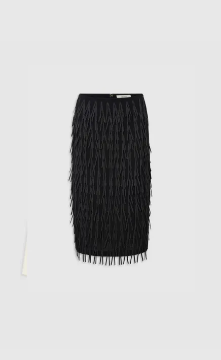 Black fringed skirt on a light background.