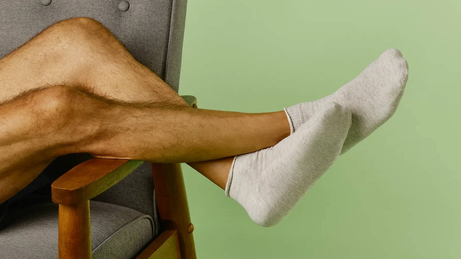 Man lounging on chair while wearing SmartKnit Seamless Socks