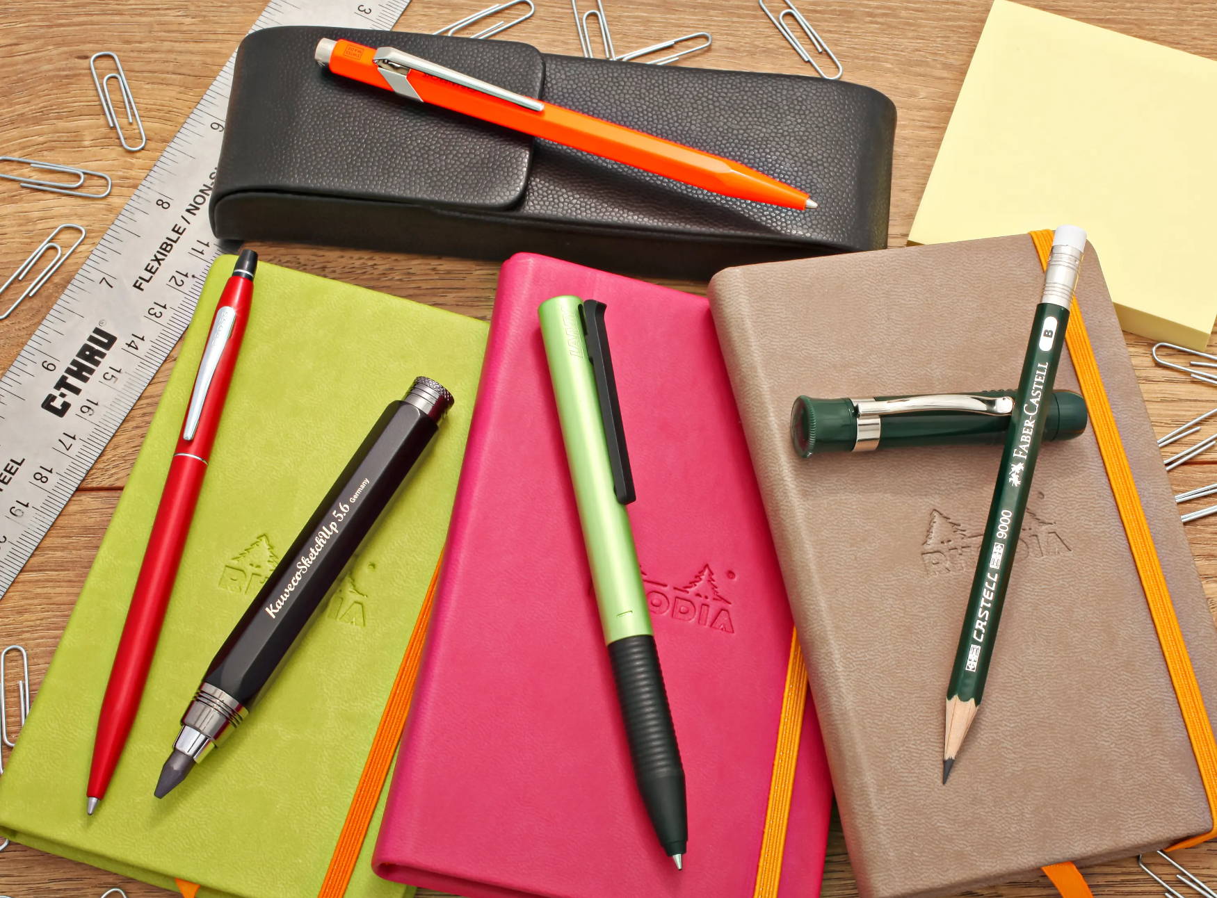 A pack of our good pens on top of notebooks