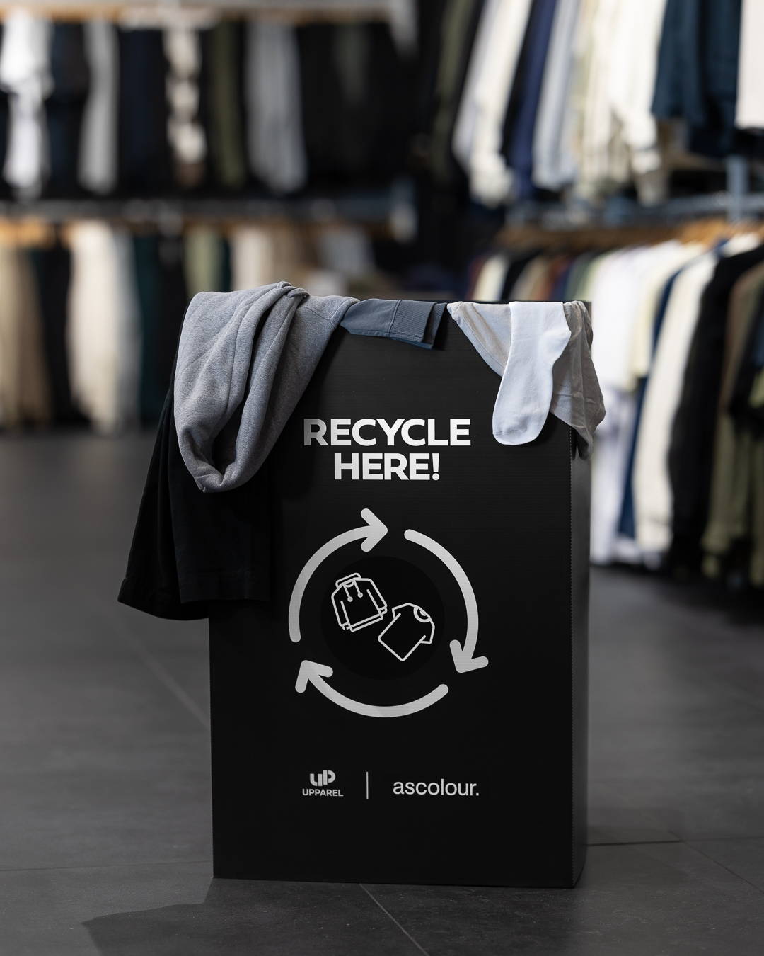Upparel sign with the words 'recycled here' in bold lettering