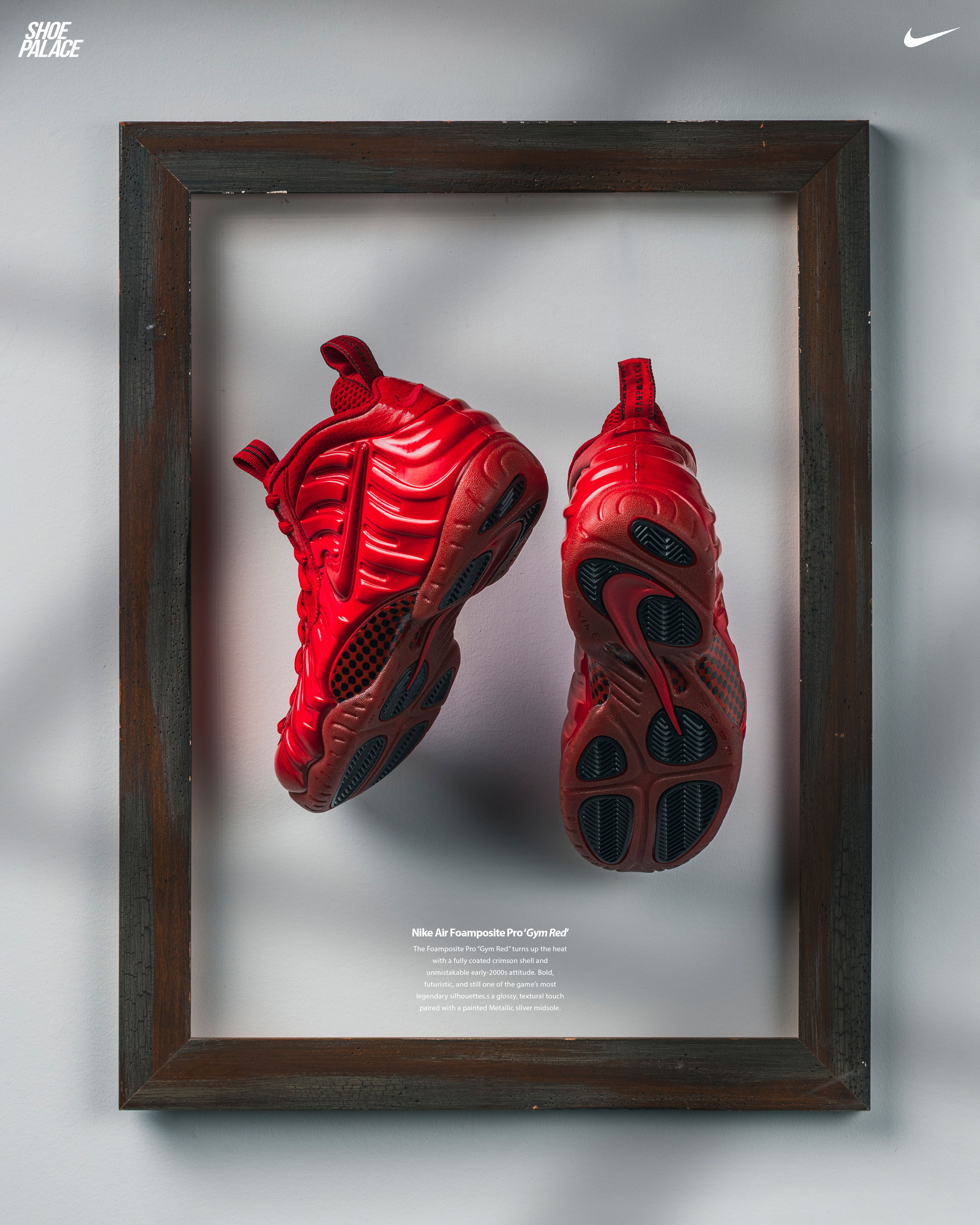 A pair of red sneakers displayed in a framed presentation.