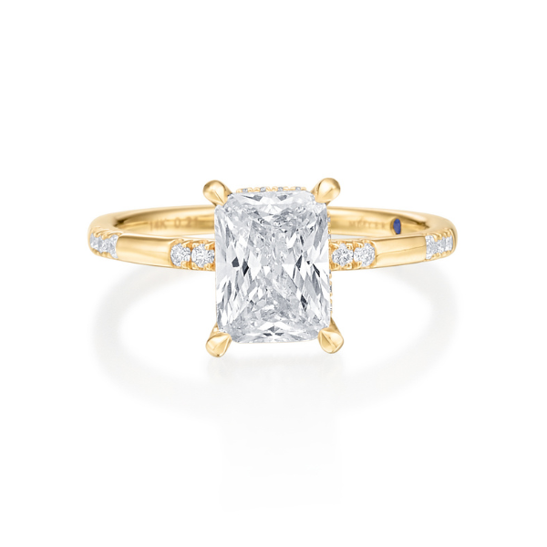 Gold ring with a large rectangular diamond and smaller accent stones.