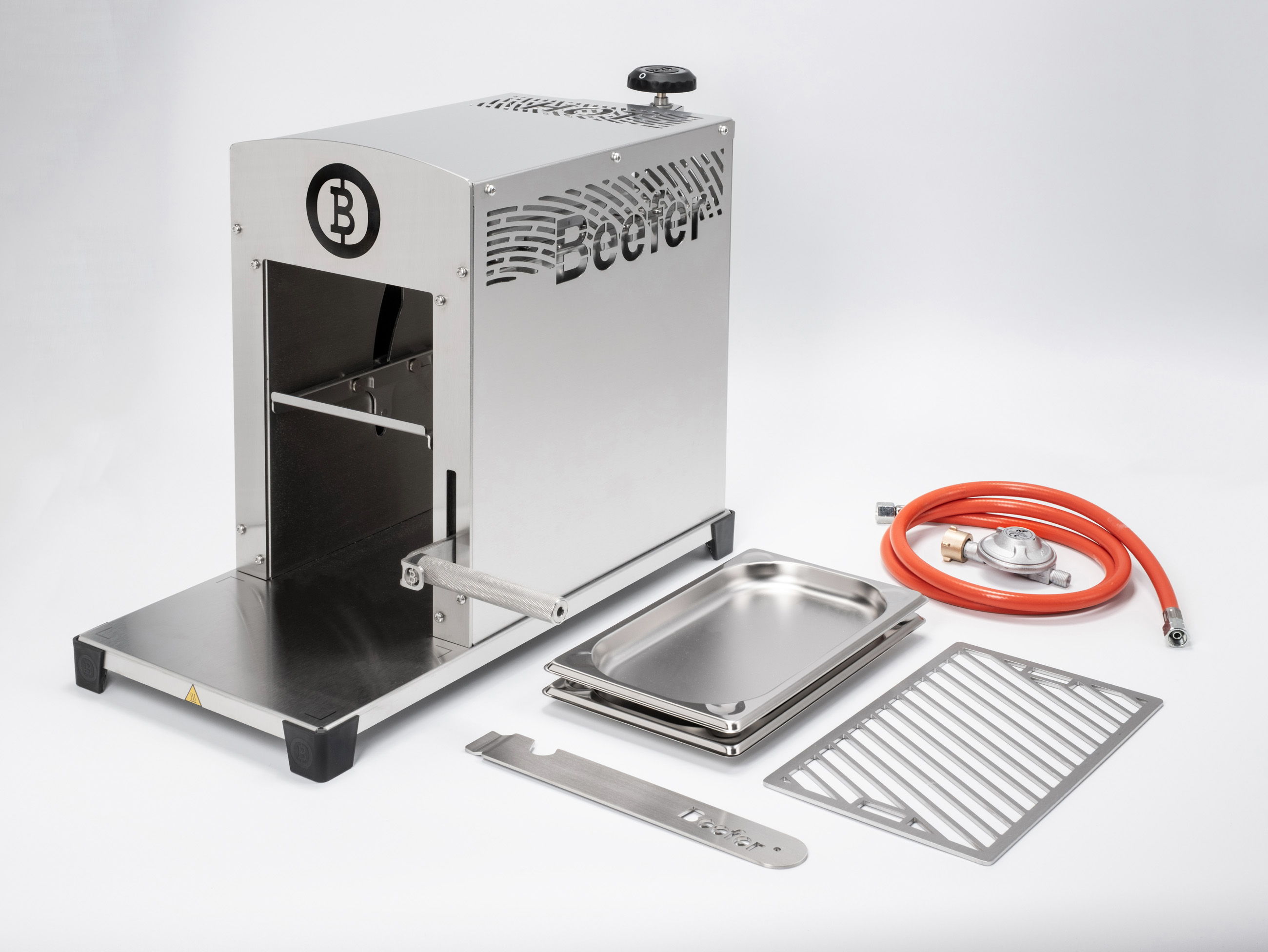 A stainless steel appliance with accessories for cooking or grilling.