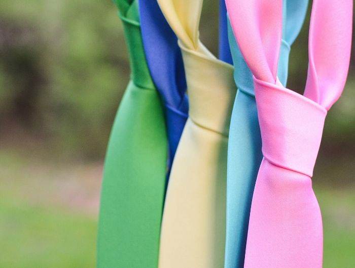 Five tied neckties in assorted solid colors 