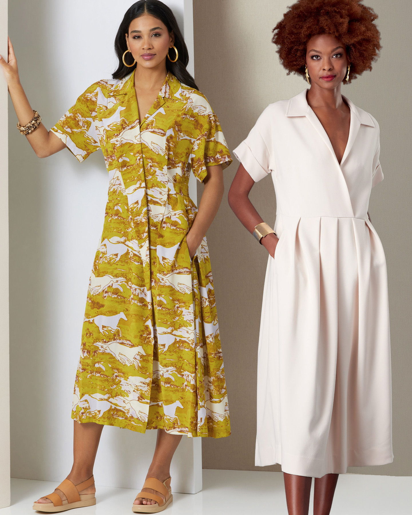 Two women modeling stylish dresses in a fashion setting.