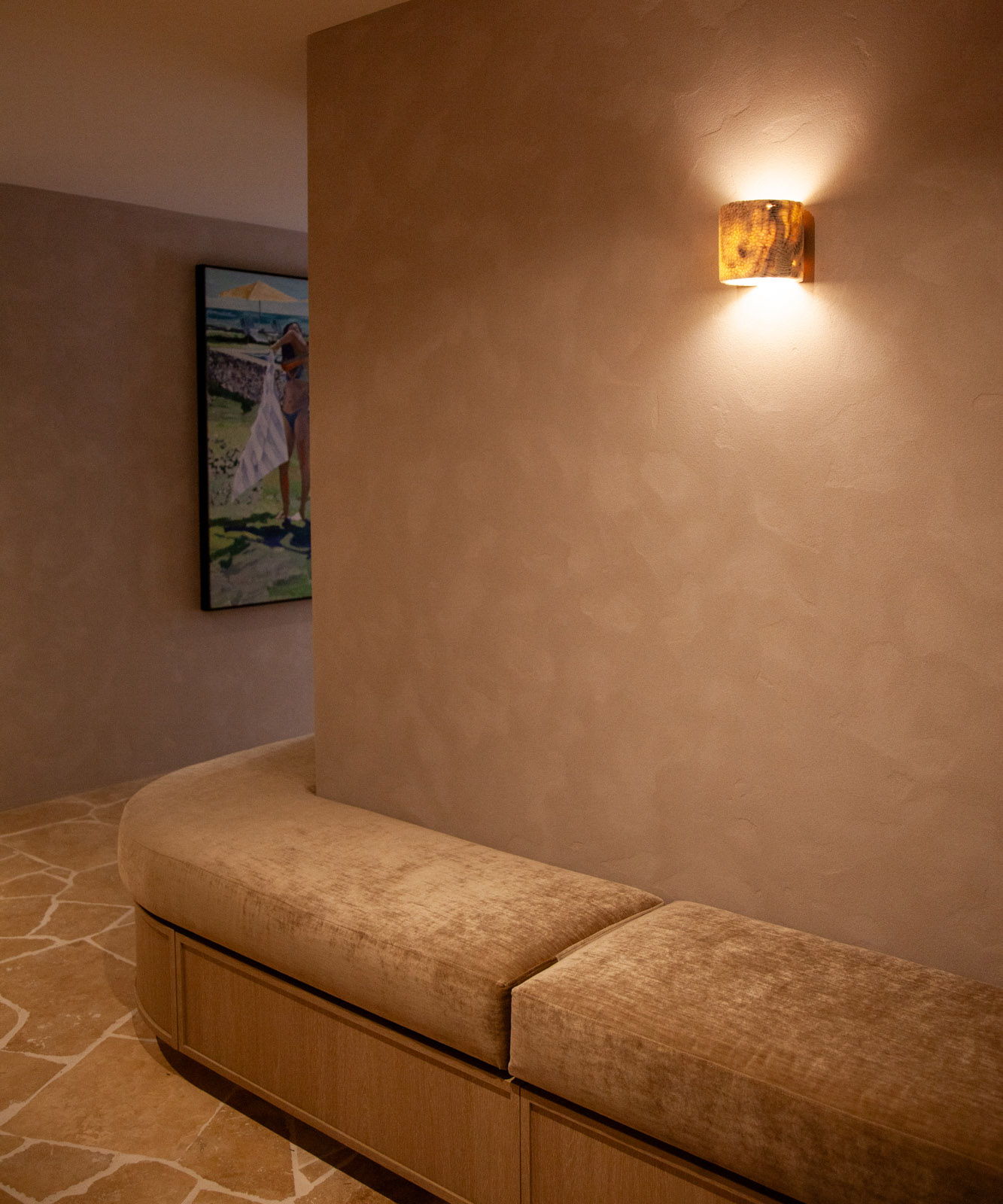 Interior hallway with a bench, wall art, and the Fossil Coral Tube Wall Sconce