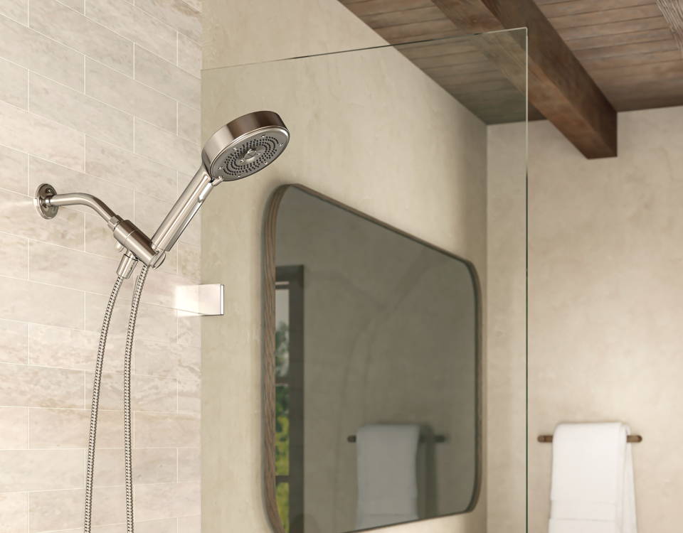 Image of a Chrome Nebia Merced 5-Setting Handshower on white tile walls. Bathroom has modern walnut framed vanity mirror with rustic wooden slatted ceiling and beam. 