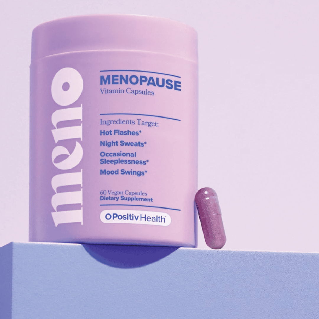 Container of menopause health capsules with one capsule beside it.