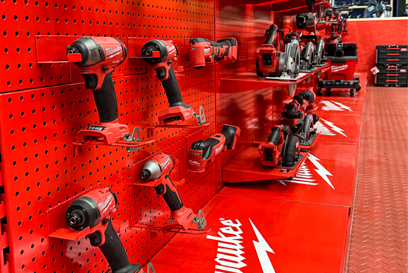 Display of red power tools on a pegboard.