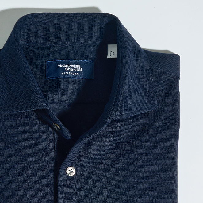 Navy blue collared shirt with a button and label.