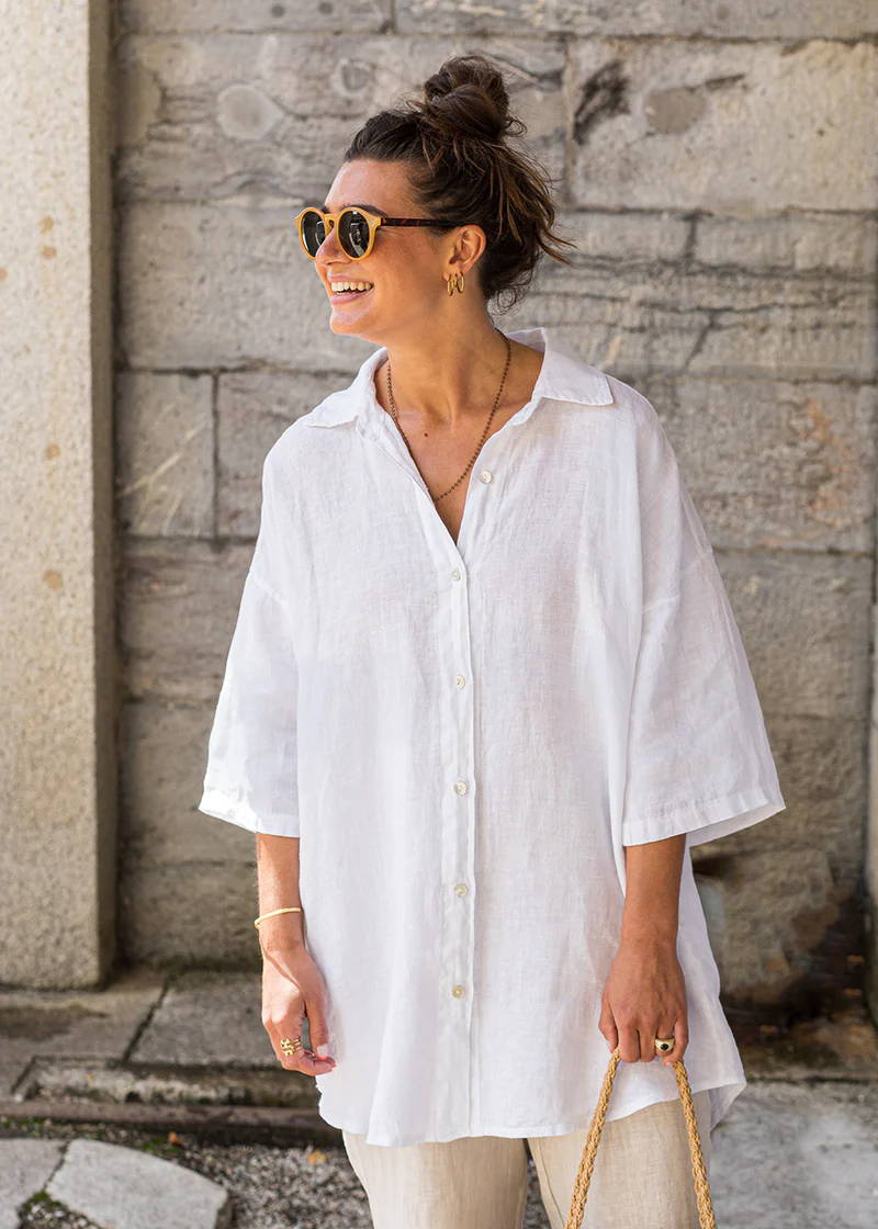 A model wearing a white oversized linen shirt